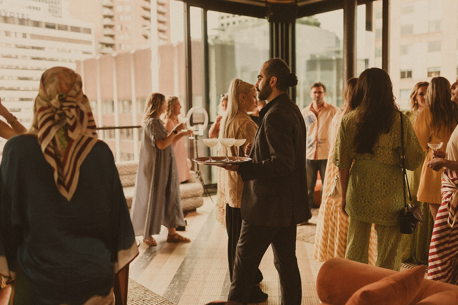 Guests at Sky Bar Sydney wearing Bohemian Traders Resort ’25 Golden Hour Club.