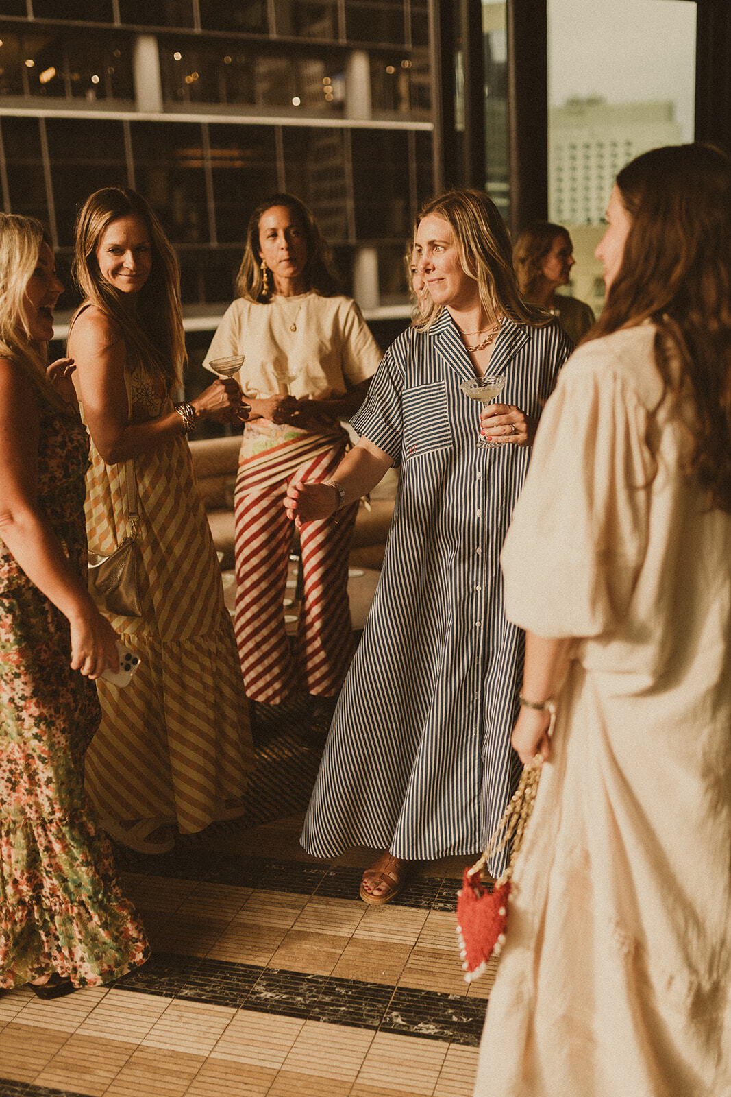 Guests at Sky Bar Sydney wearing Bohemian Traders Resort ’25 Golden Hour Club.