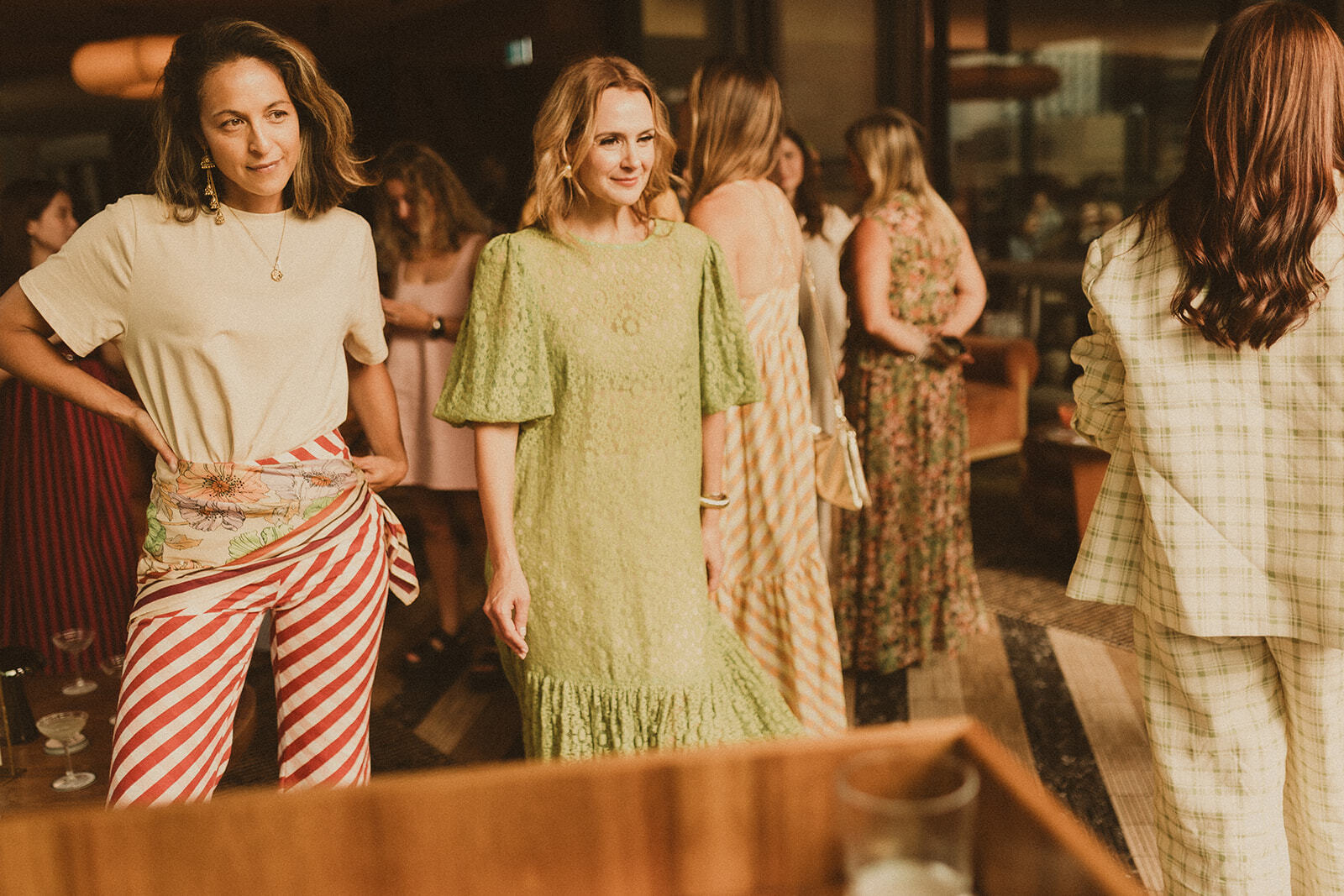 Guests at Sky Bar Sydney wearing Bohemian Traders Resort ’25 Golden Hour Club.