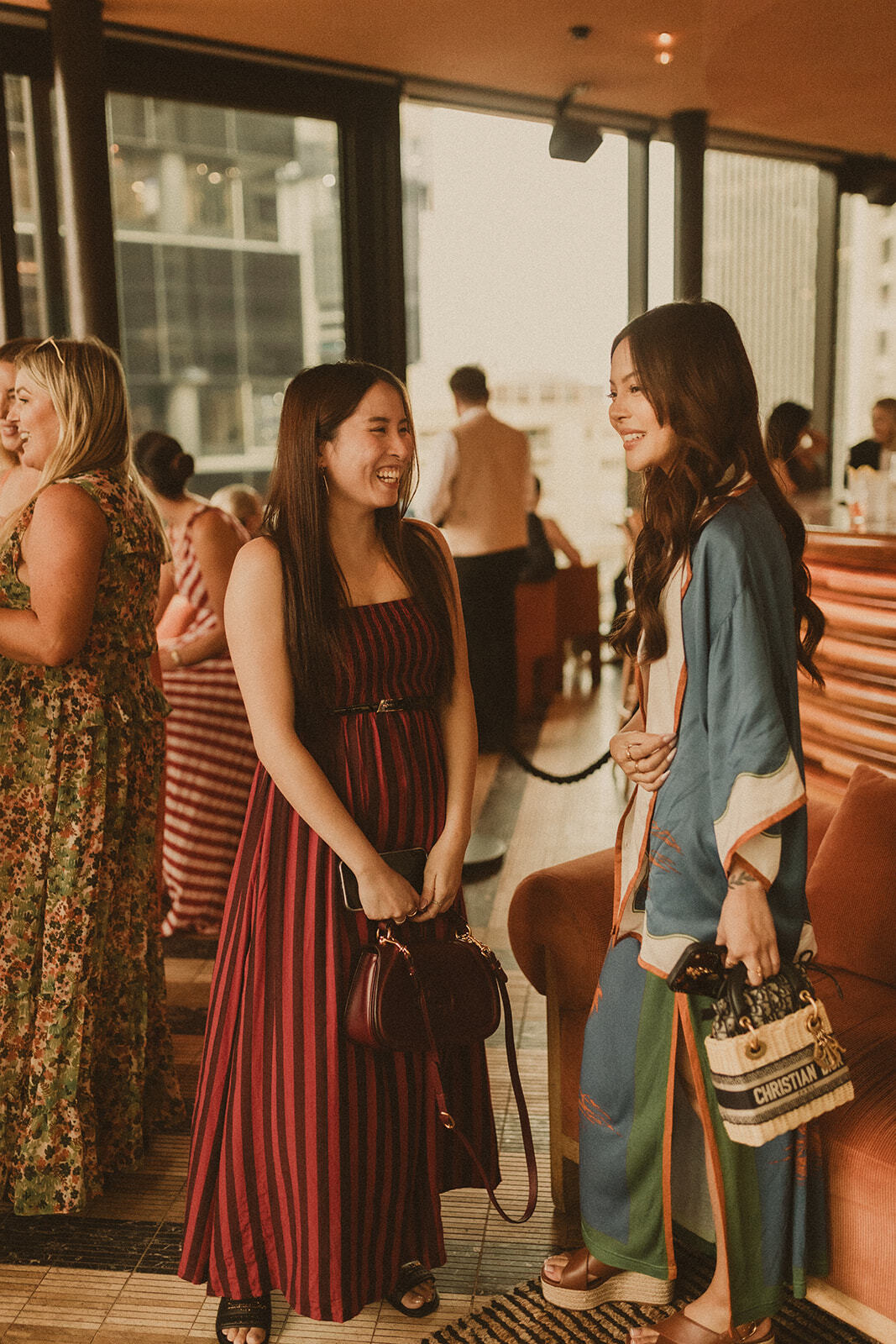 Guests at Sky Bar Sydney wearing Bohemian Traders Resort ’25 Golden Hour Club.