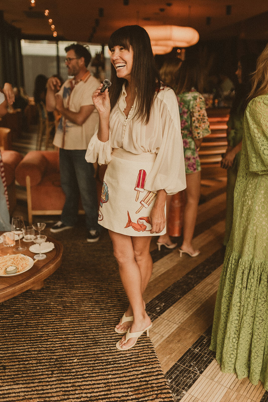 Guests at Sky Bar Sydney wearing Bohemian Traders Resort ’25 Golden Hour Club.