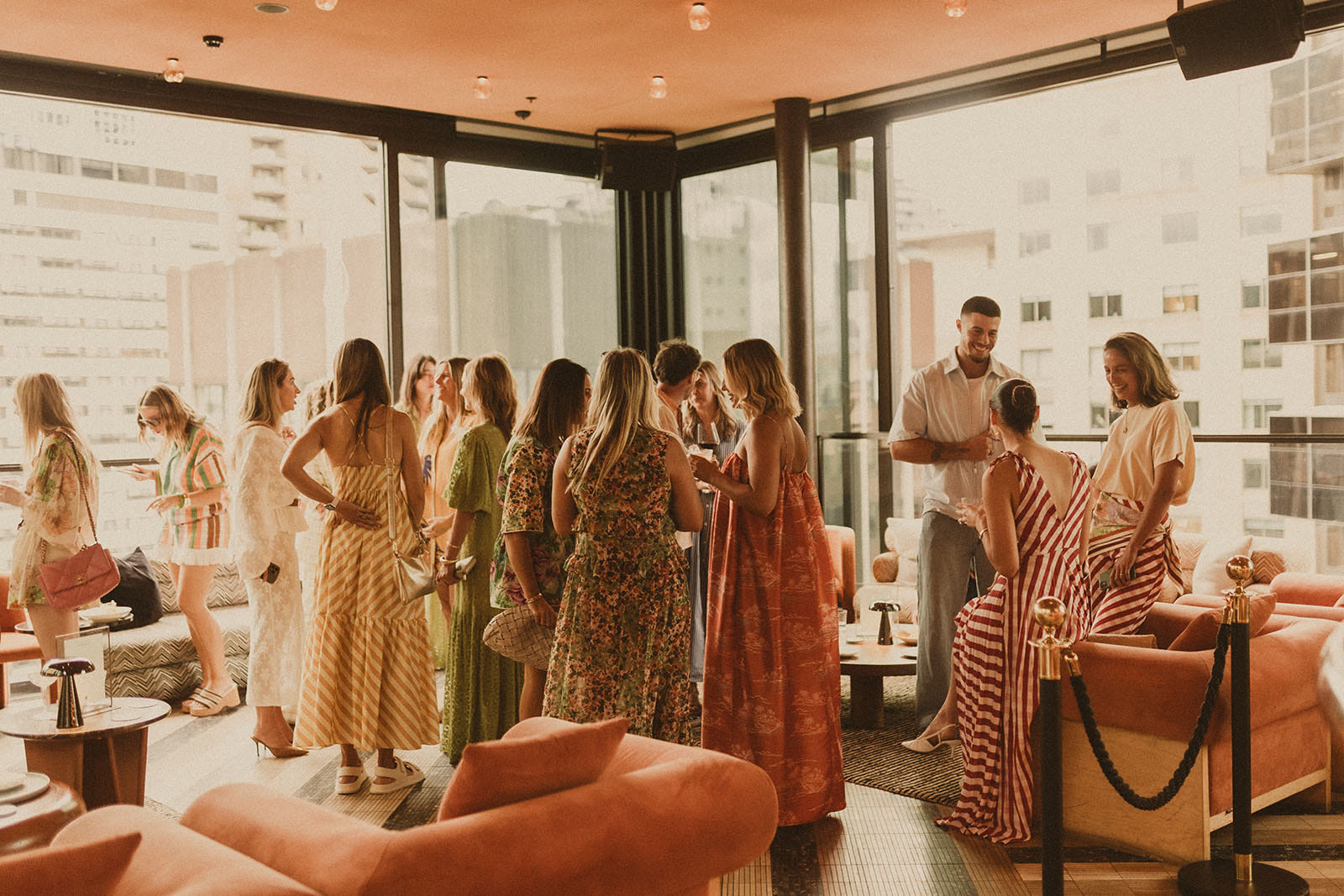 Guests at Sky Bar Sydney wearing Bohemian Traders Resort ’25 Golden Hour Club.